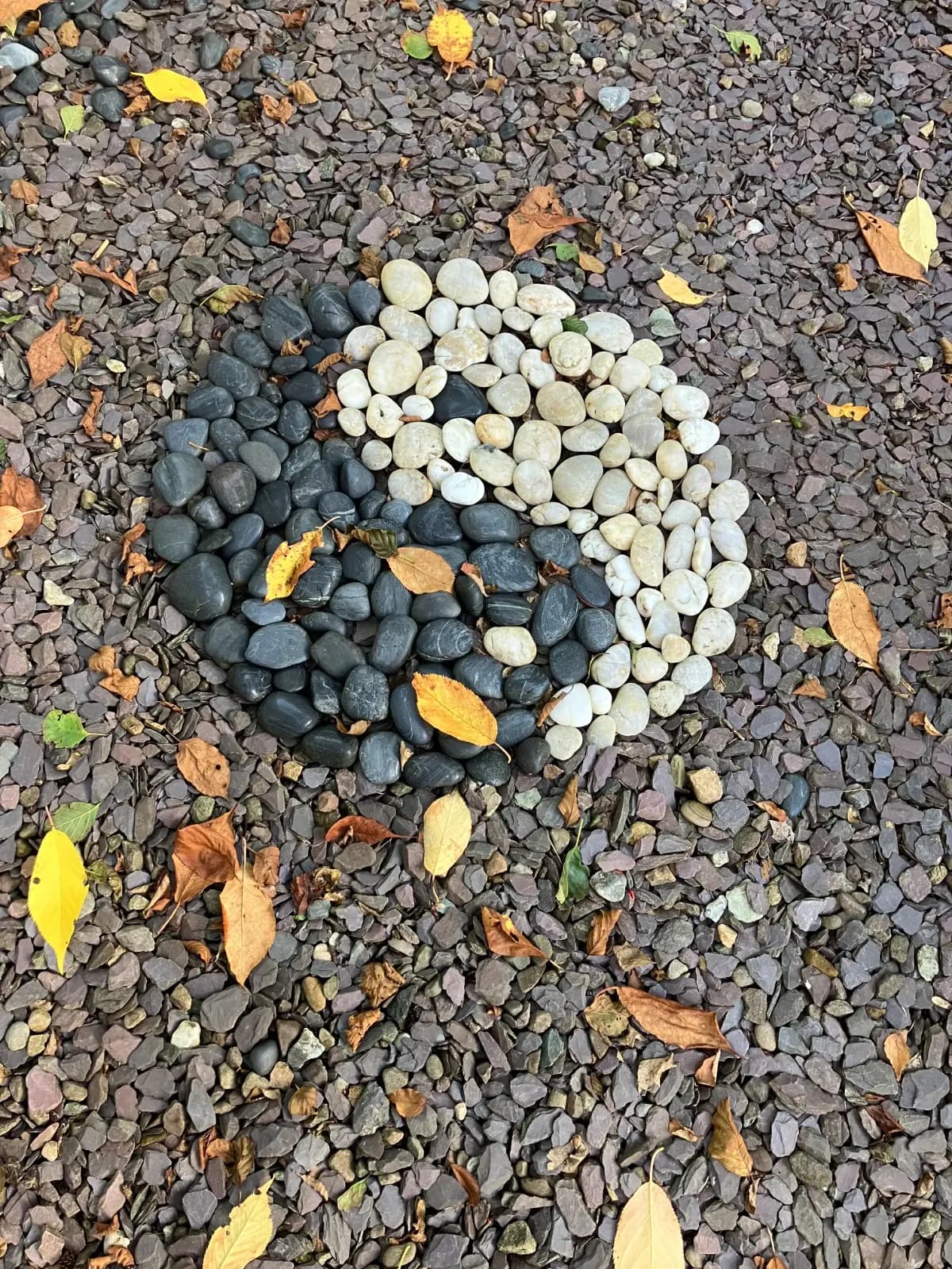 Yin-yang symbol made from stones in Castlebank Park
